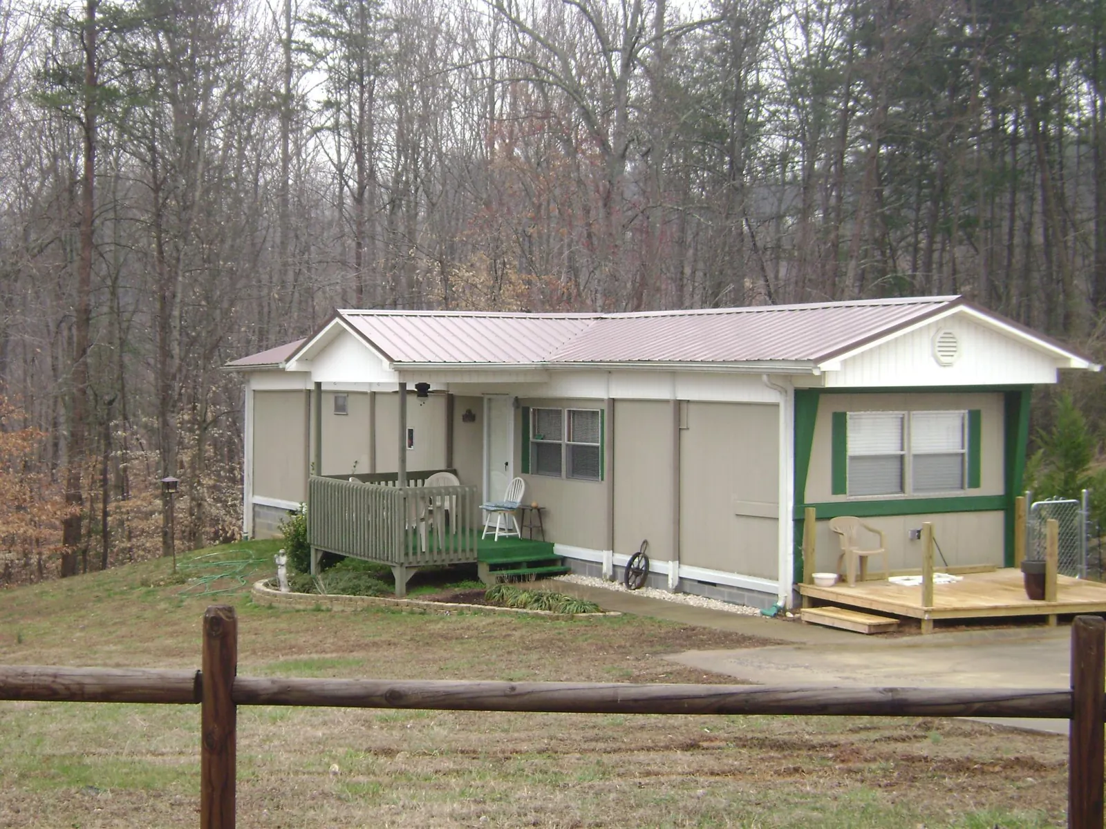 Mauve metal roof on a manufactured home with a new front deck in Mill Creek